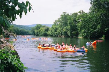 a group of people rowing a boat in the water