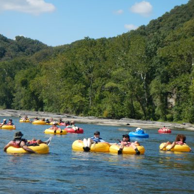 a group of people in a small boat in a body of water