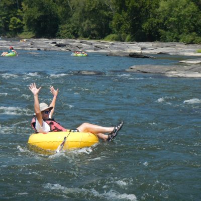 a group of people riding on the back of a boat in the water