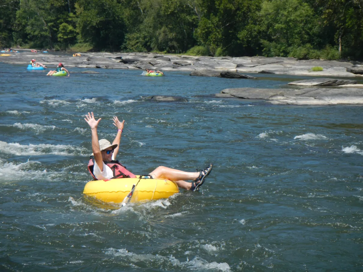 a group of people riding on the back of a boat in the water