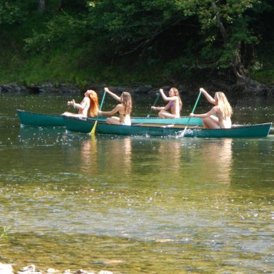 a group of people rowing a boat in the water