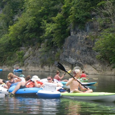 a group of people rowing a boat in the water
