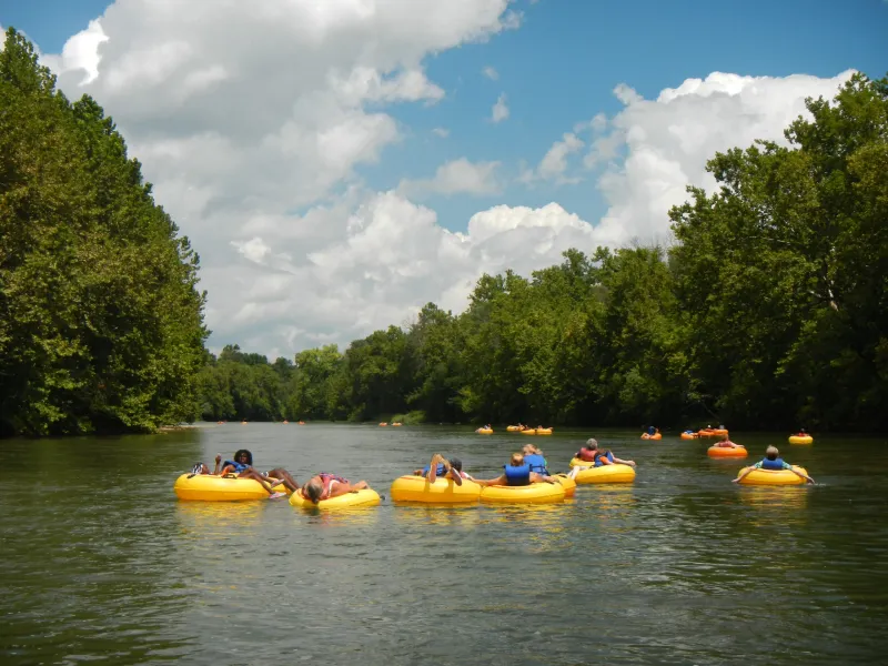 a group of people in a small boat in a body of water