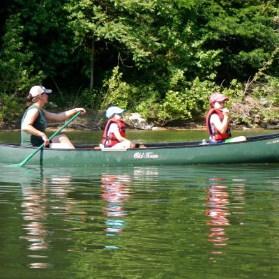 a group of people rowing a boat in the water