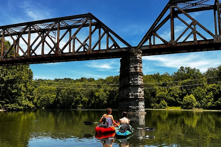 a train crossing a bridge over a body of water