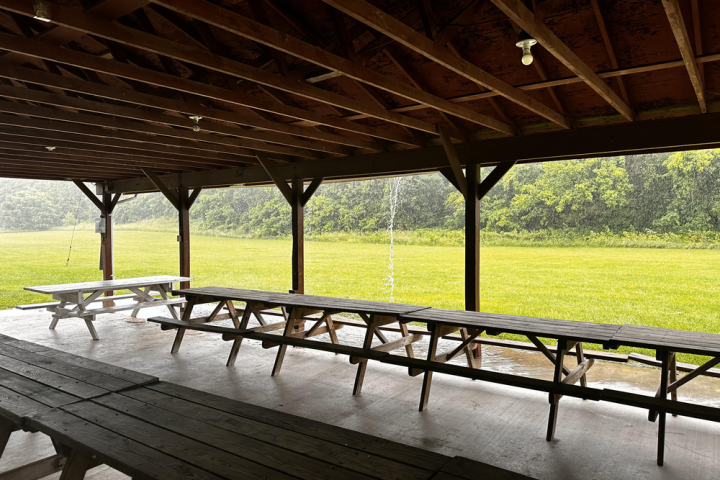 an empty park bench next to a body of water
