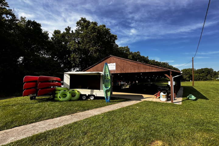 a person sitting on a bench in a park