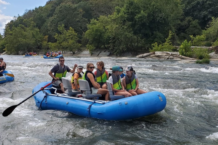 a group of people on a raft in a body of water