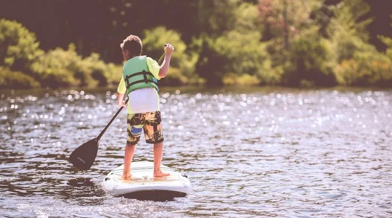 a person riding a surf board on a body of water